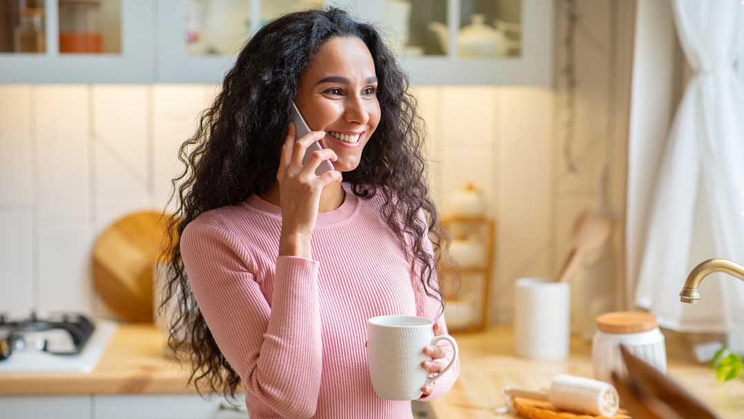 woman on phone after seeing Google Ad holding coffee mug